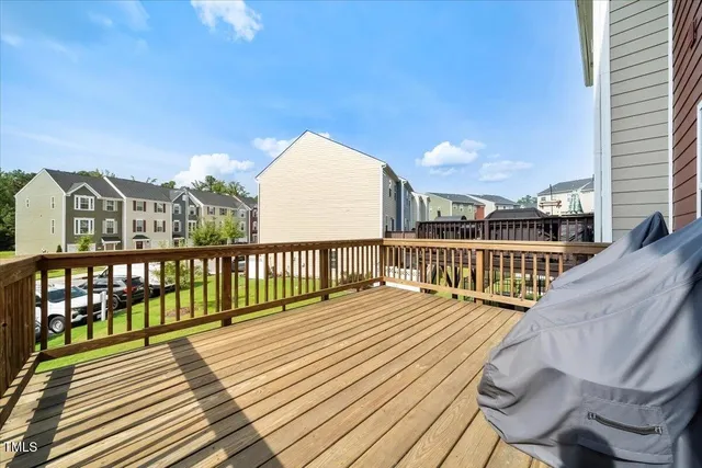 a view of balcony with wooden floor and fence