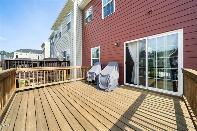 a view of a deck with wooden floor and barbeque oven