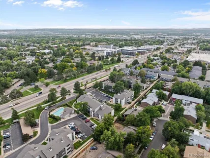 a sign of golf club on a wall under a tree