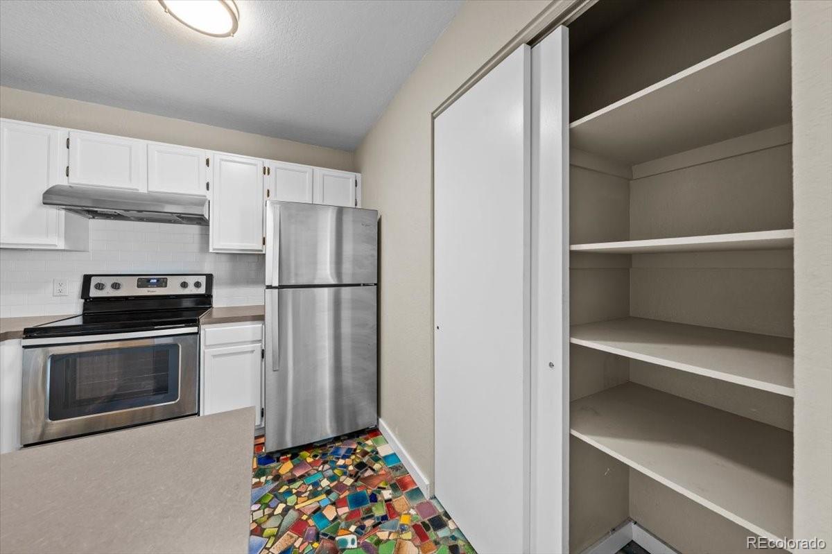 3545 28th Street, Unit 304 Boulder, CO 80301 - Photo 8 of 23 a kitchen with a refrigerator and a stove top oven