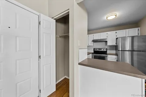 a bedroom with a large bed and a potted plant