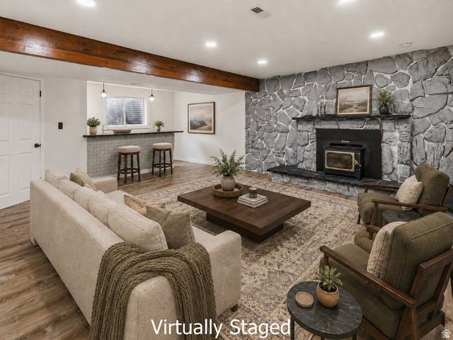 2693 Teal Way Sandy, UT 84093 - Photo 23 of 50 Spacious living area featuring a prominent stone accent wall with an integrated fireplace and wood-burning stove