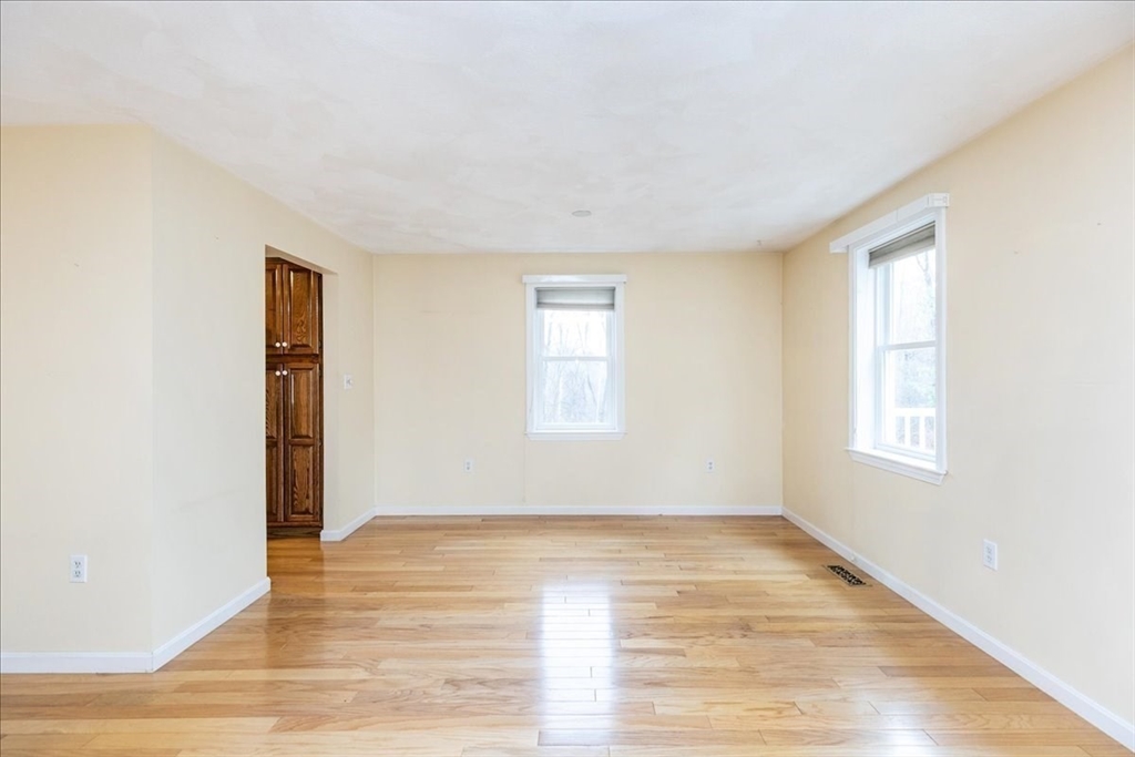 22 Collins Street, Unit 46 Danvers, MA 01923 - Photo 13 of 37 an empty room with wooden floor and windows