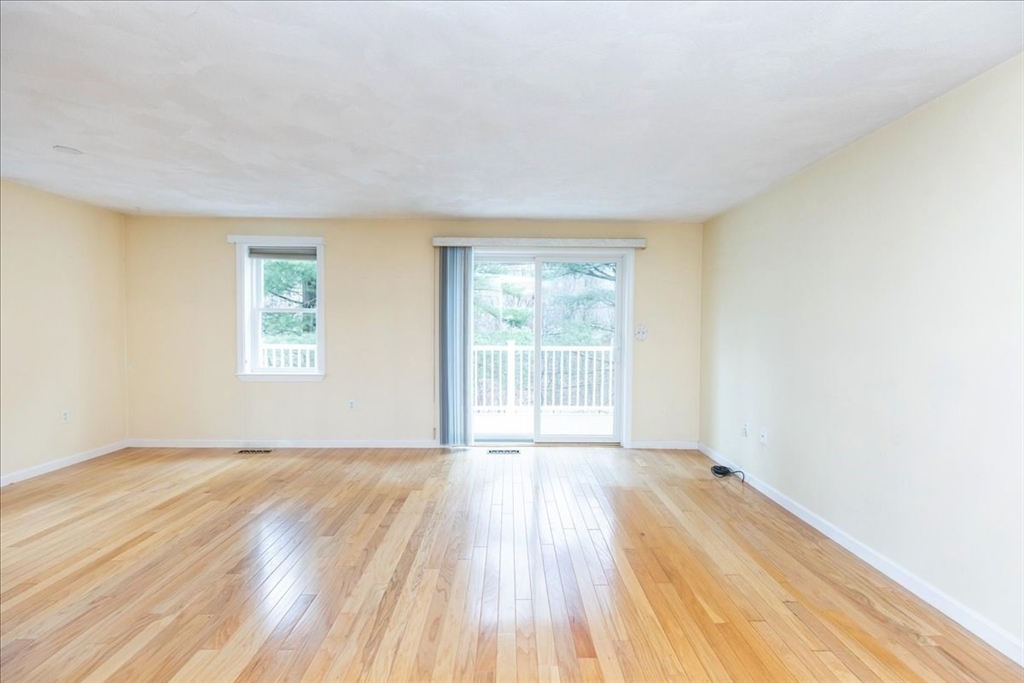 22 Collins Street, Unit 46 Danvers, MA 01923 - Photo 14 of 37 an empty room with wooden floor and windows