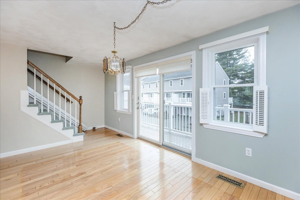 22 Collins Street, Unit 46 Danvers, MA 01923 - Photo 20 of 37 a view of an empty room with wooden floor and a window