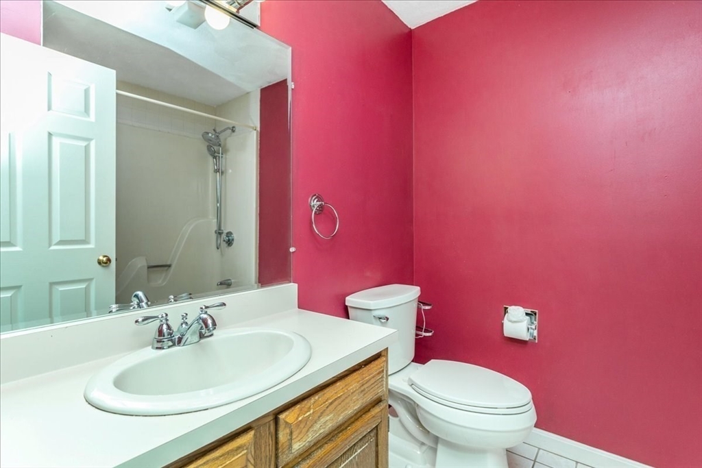 22 Collins Street, Unit 46 Danvers, MA 01923 - Photo 25 of 37 a bathroom with a sink a toilet and a mirror