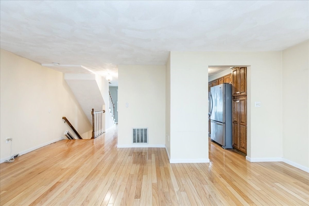 22 Collins Street, Unit 46 Danvers, MA 01923 - Photo 7 of 37 a view of empty room with wooden floor and fan