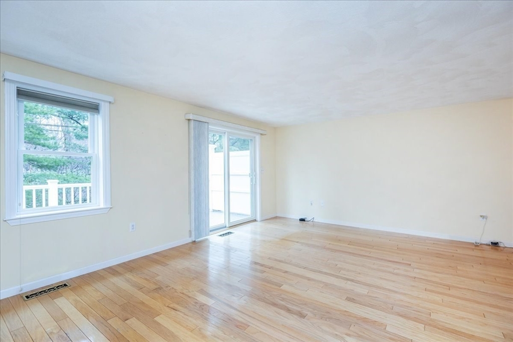 22 Collins Street, Unit 46 Danvers, MA 01923 - Photo 10 of 37 a view of an empty room with wooden floor and a window