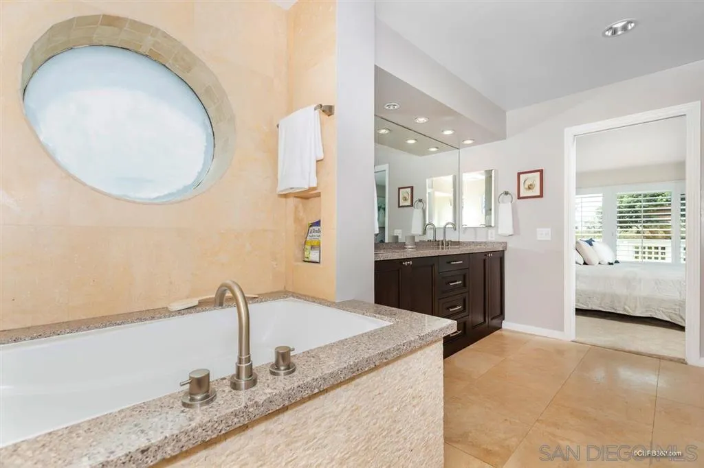 1031 America Way Del Mar, CA 92014 - Photo 17 of 25 a bathroom with a granite countertop sink a mirror and a bathtub