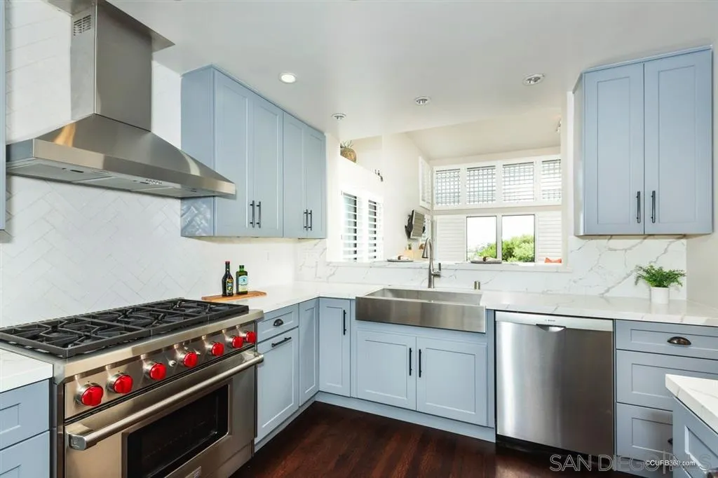 1031 America Way Del Mar, CA 92014 - Photo 9 of 25 a kitchen with granite countertop stainless steel appliances a sink stove and cabinets