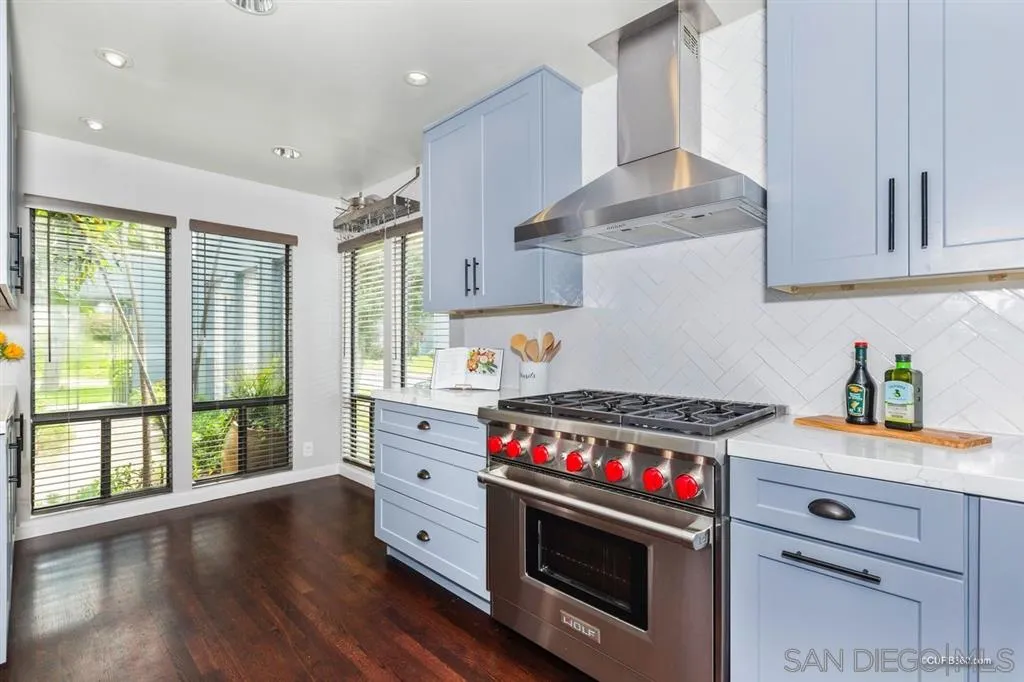 1031 America Way Del Mar, CA 92014 - Photo 10 of 25 a kitchen with granite countertop a stove and a wooden floors