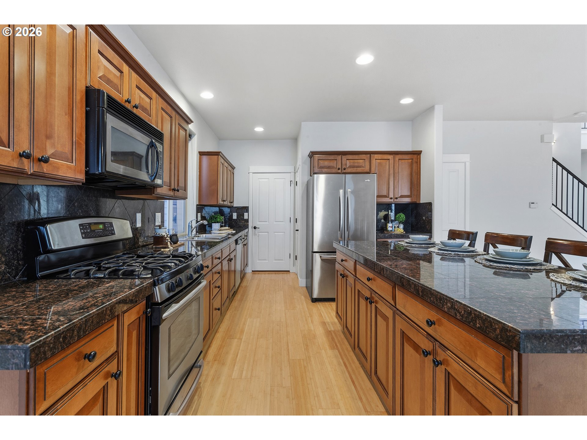 2502 Northwest Parnell Terrace Portland, OR 97229 - Photo 14 of 48 a kitchen with stainless steel appliances granite countertop a stove a sink dishwasher a microwave oven and a refrigerator