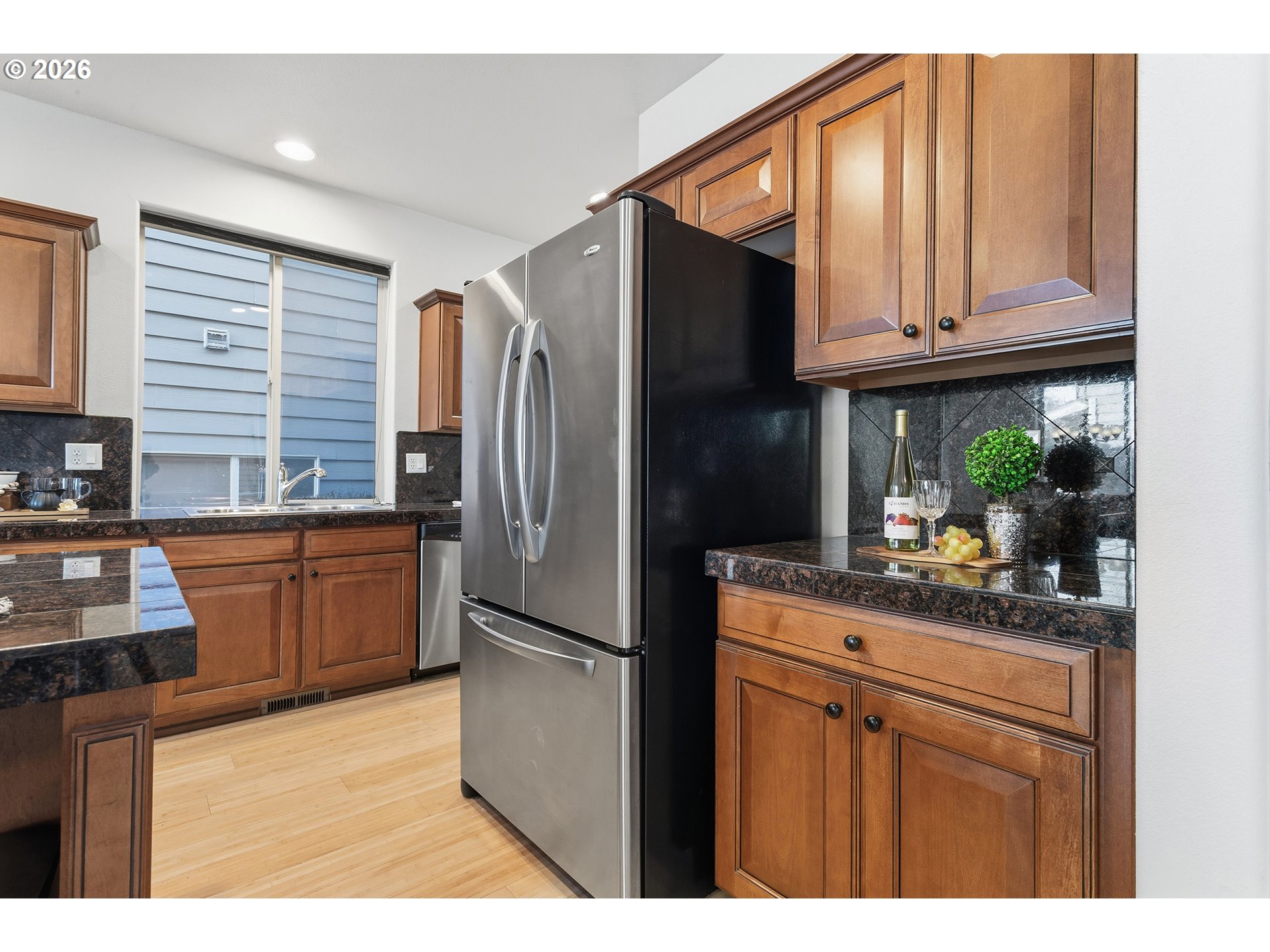 2502 Northwest Parnell Terrace Portland, OR 97229 - Photo 15 of 48 a kitchen with stainless steel appliances granite countertop a refrigerator and a stove top oven
