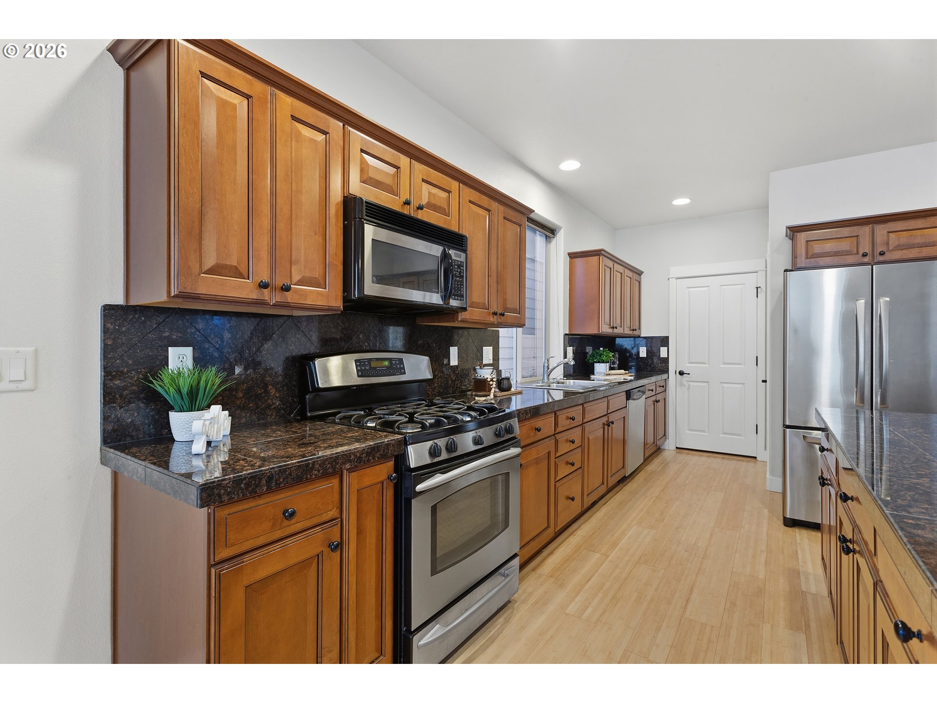2502 Northwest Parnell Terrace Portland, OR 97229 - Photo 16 of 48 a kitchen with stainless steel appliances granite countertop a refrigerator a stove top oven a sink and dishwasher