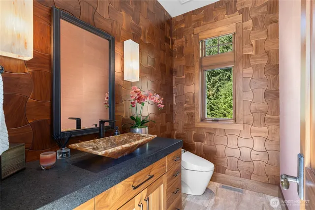 a bathroom with a sink a toilet and a shower curtain