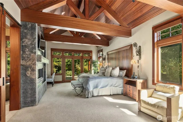 a bedroom with furniture and large windows