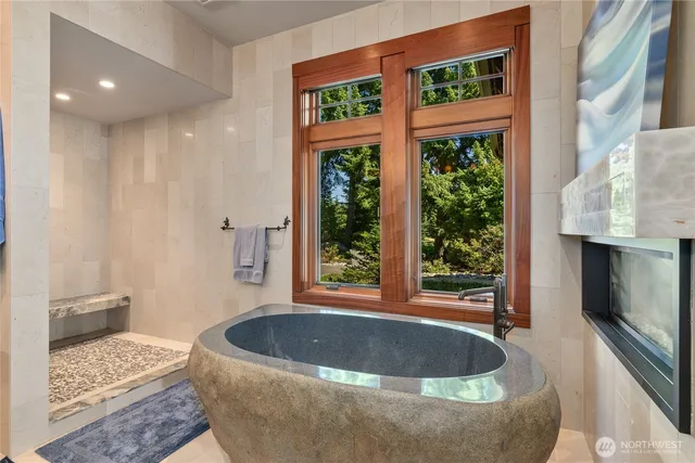 a living room with a fireplace and a large window