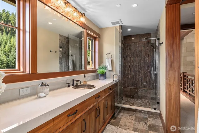 a bathroom with a shower sink and mirror