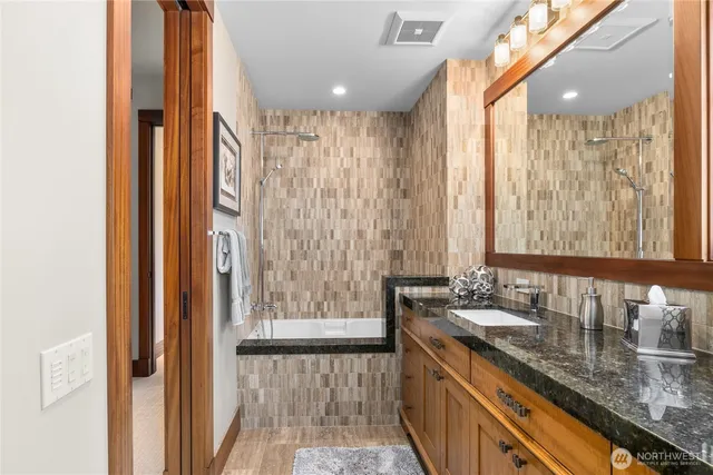 a bathroom with a granite countertop sink and a mirror