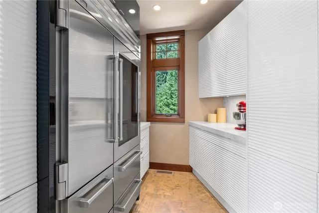 a kitchen with a refrigerator and window