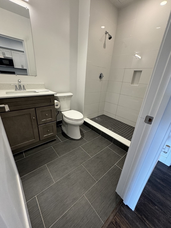 6 Needhams Landing Road, Unit 503 Lynn, MA 01905 - Photo 5 of 9 a bath room with a sink a toilet and a mirror