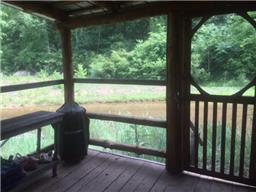 5025 Poplar Grove Road McEwen, TN 37101 - Photo 3 of 14 Screened in porch with creek view.