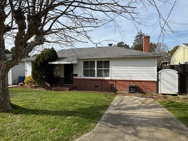 a front view of a house with a yard table and chairs