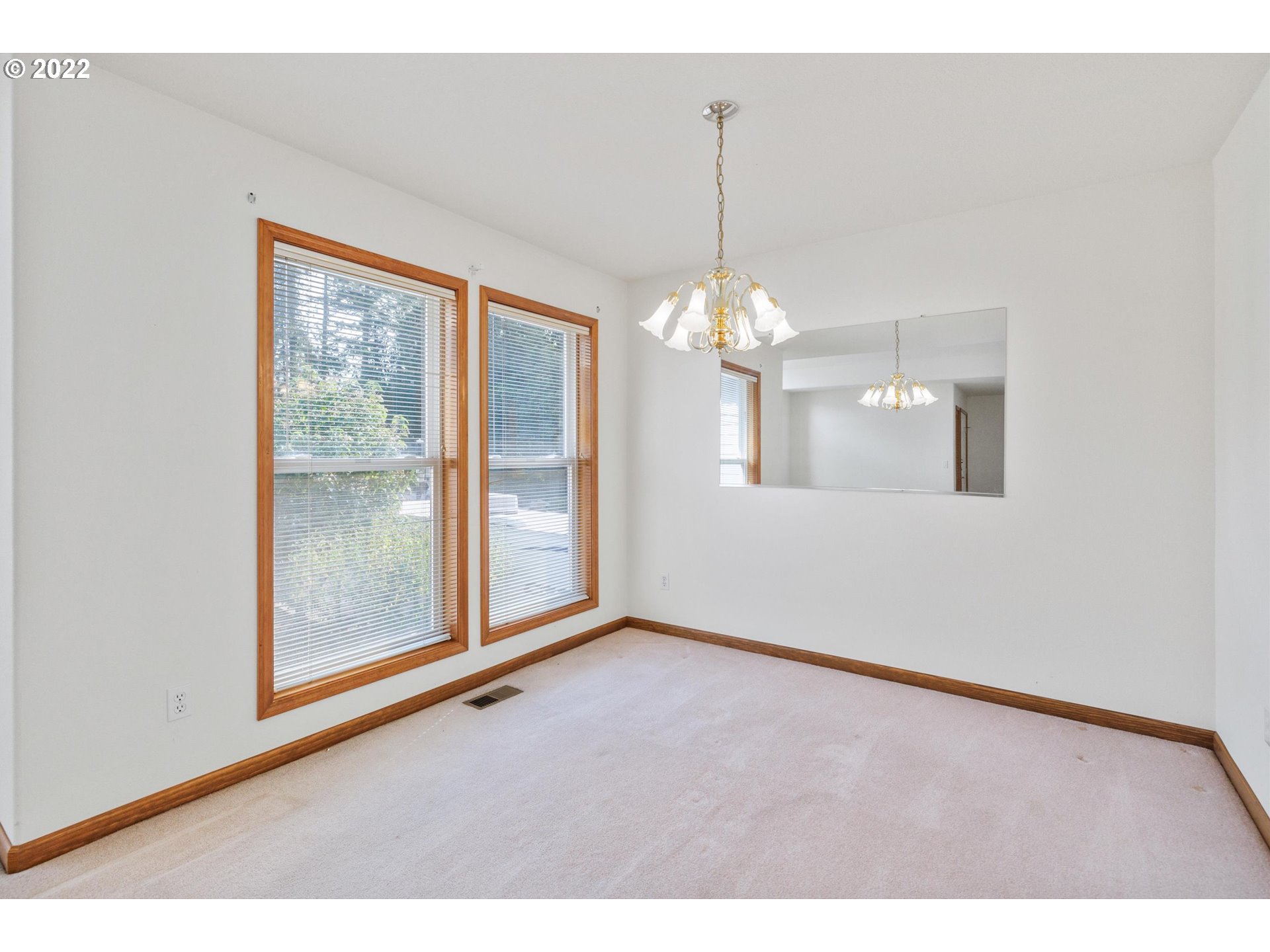 36930 Eldridge Drive Sandy, OR 97055 - Photo 7 of 32 a view of an empty room with chandelier and wooden floor