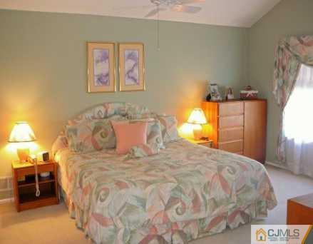 159 Salem Road North Brunswick, NJ 08902 - Photo 6 of 8 a large bed sitting in a bedroom and table