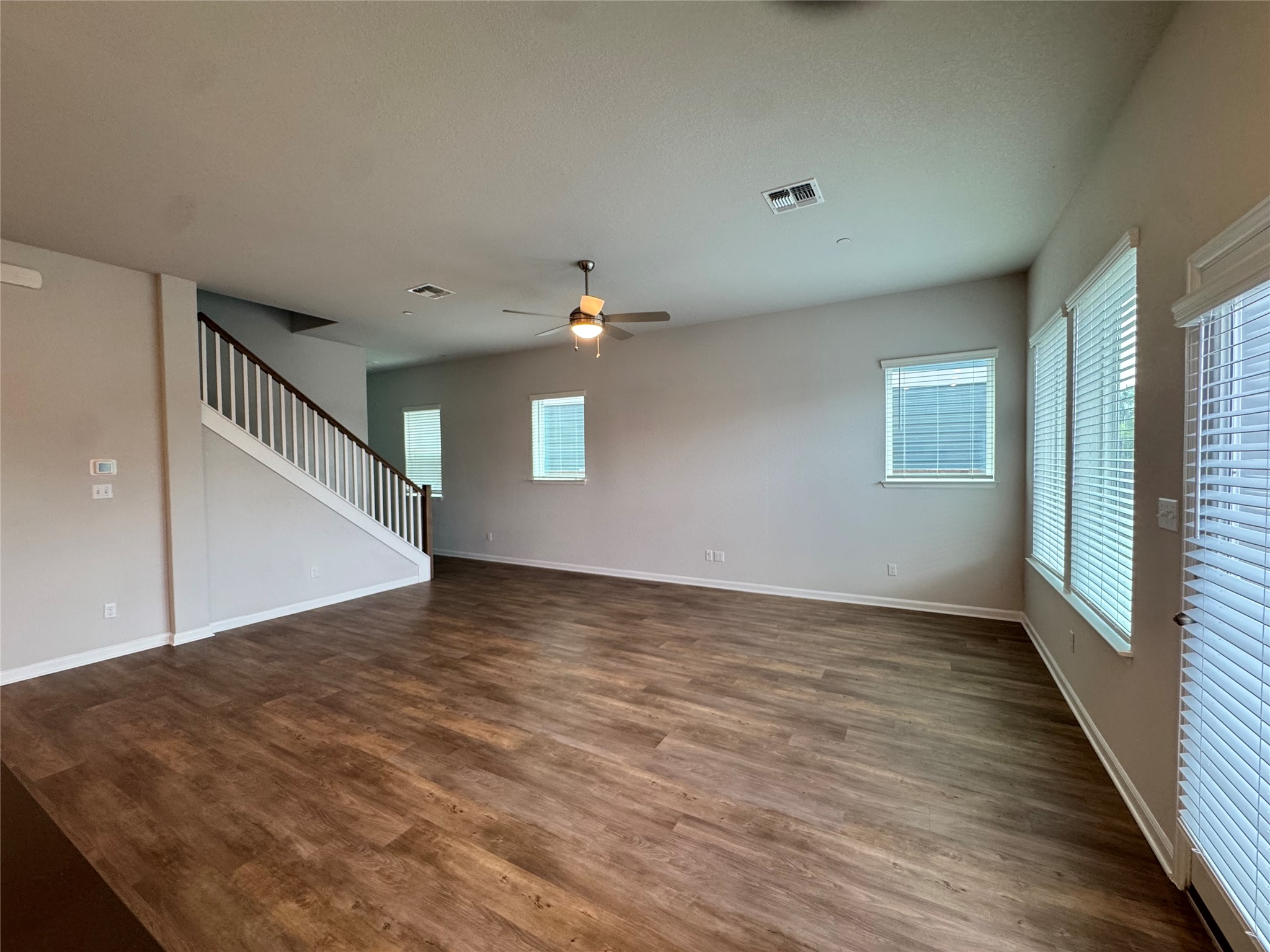 3000 Chisholm Trail Road, Unit 41 Round Rock, TX 78681 - Photo 28 of 28 An open floorplan living room with rich hardwood flooring and a classic staircase.