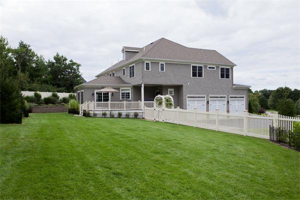 11 Cranberry Lane Hingham, MA 02043 - Photo 14 of 16 a front view of a house with a garden and yard