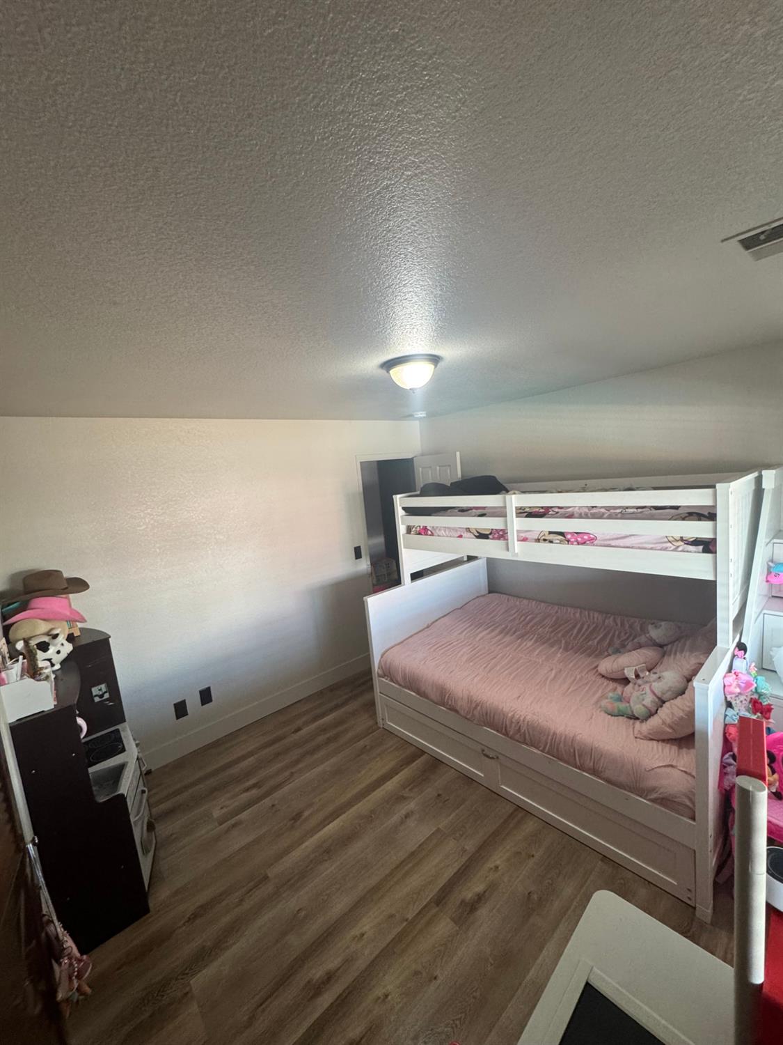 5931 Claribel Road Oakdale, CA 95361 - Photo 15 of 29 a bedroom with a bed and wooden floor