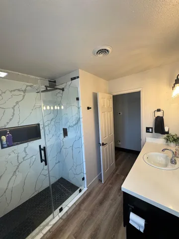 a spacious bathroom with a shower and a sink