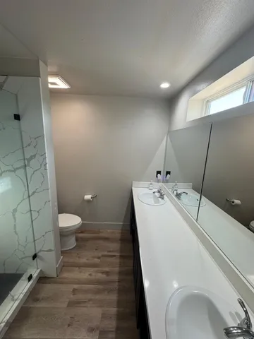 a spacious bedroom with a bed and a window