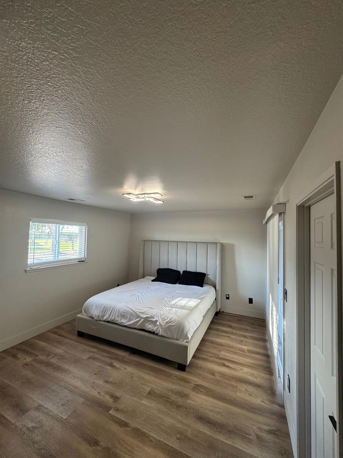 5931 Claribel Road Oakdale, CA 95361 - Photo 21 of 29 a spacious bedroom with a bed and a window