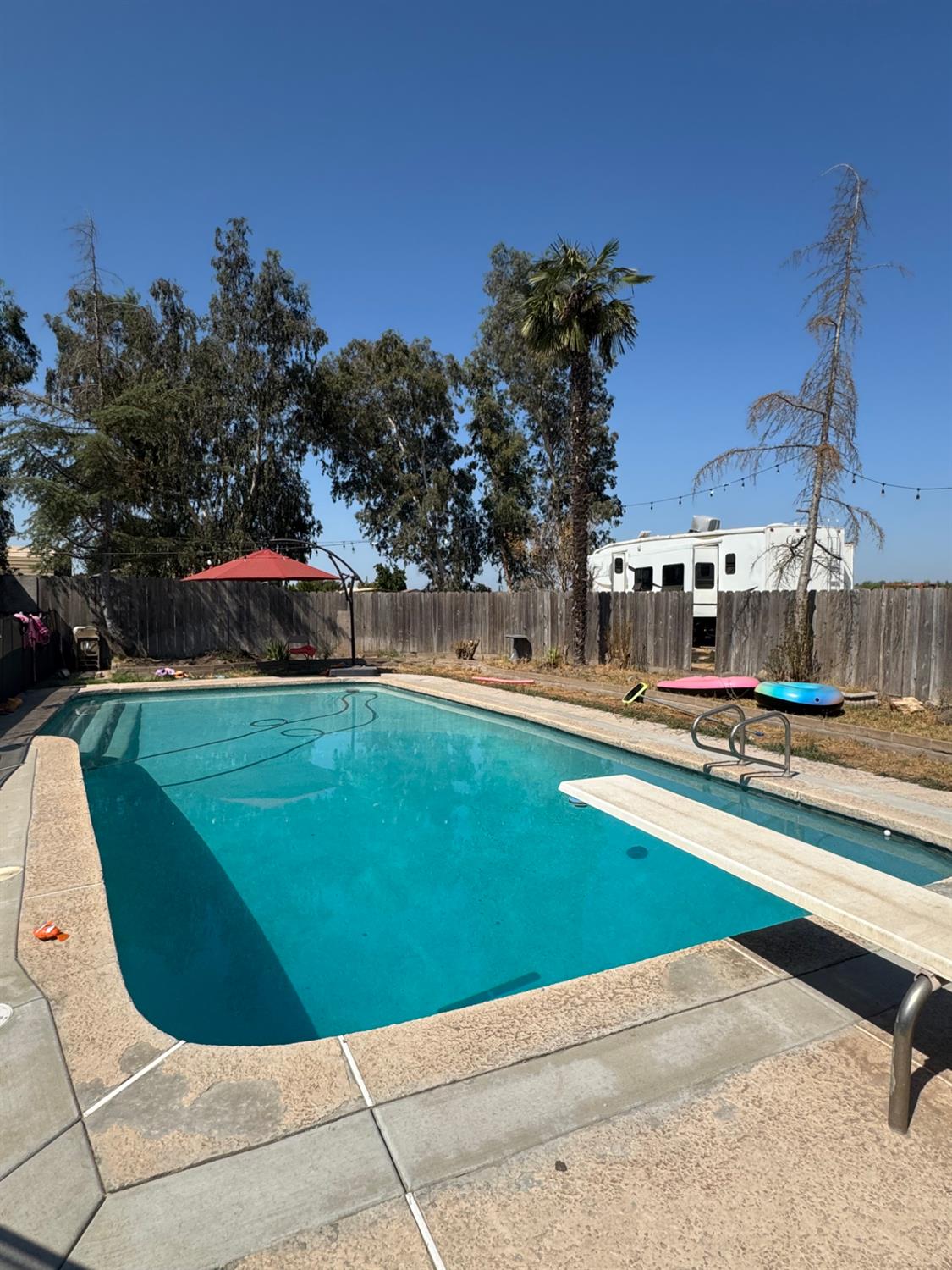 5931 Claribel Road Oakdale, CA 95361 - Photo 29 of 29 a view of swimming pool with a yard