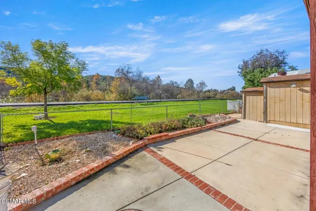 a view of a garden with a building in the background