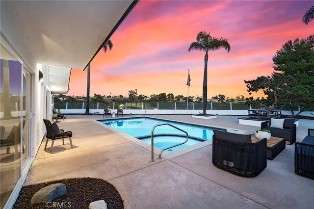 a view of a swimming pool with a lounge chair