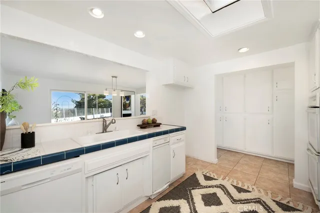 a hallway with sink and mirror