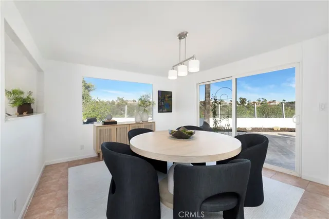 a dining room with furniture a chandelier and wooden floor