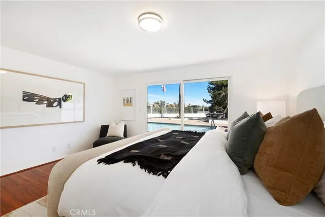 a large bedroom with a large bed and a large window