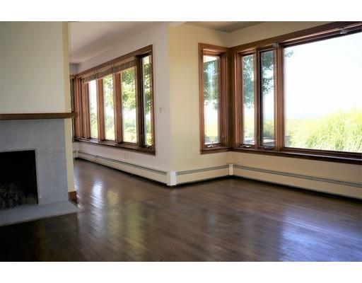 232 Still River Road Harvard, MA 01451 - Photo 20 of 41 a view of an empty room with wooden floor and a window
