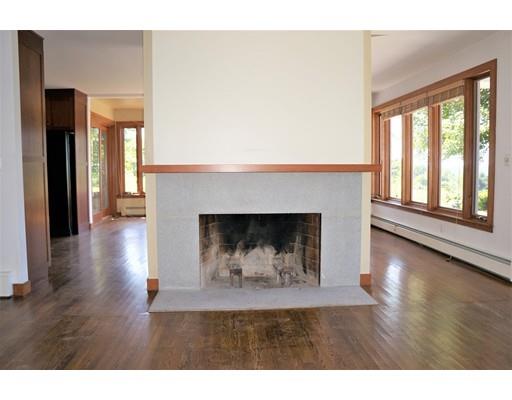 232 Still River Road Harvard, MA 01451 - Photo 21 of 41 a view of an empty room with wooden floor and a fireplace
