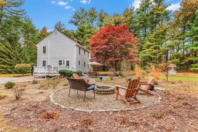 a view of a house with backyard and sitting area