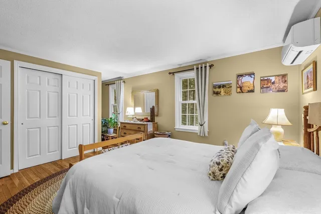 a spacious bedroom with a bed and a window