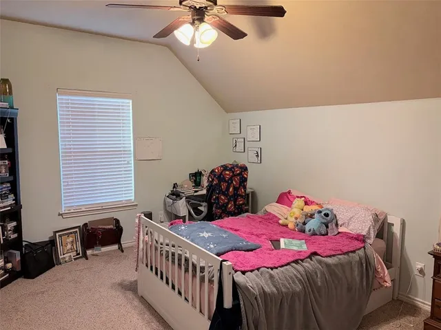 a bedroom with two beds and a baby crib