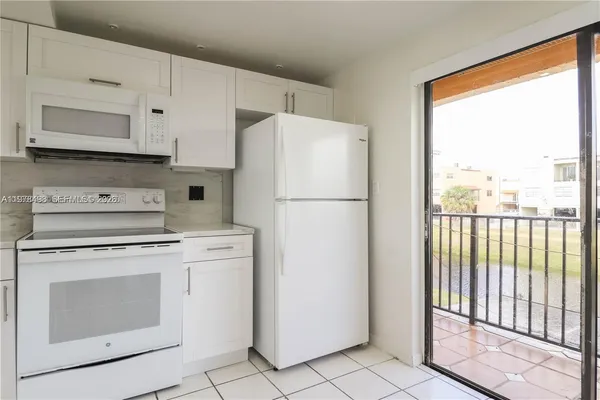 a kitchen with a sink cabinets and window