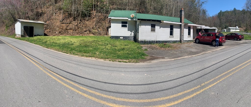 2557 Happy Hollow Road Sevierville, TN 37862 - Photo 11 of 17 a view of a house with a small yard and a car parked in front of it