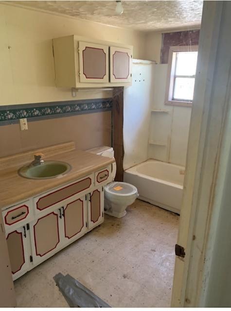 2557 Happy Hollow Road Sevierville, TN 37862 - Photo 13 of 17 a bathroom with a granite countertop toilet a sink and bathtub