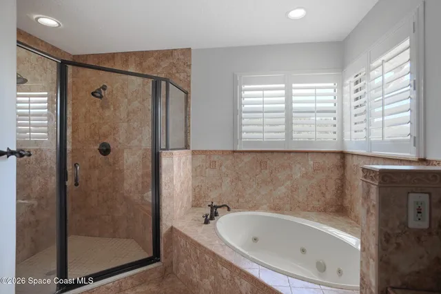 a bathroom with a bathtub and a shower